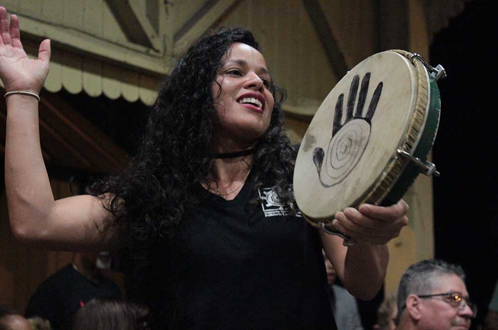 Woman playing a traditional drum instrument