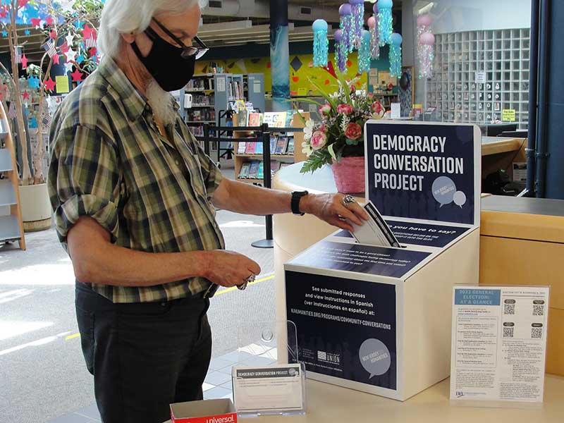 Person placing DCP card in Storybox at a library