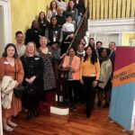 Group of presenters and staff at the Community History 2023 Showcase, about 2 dozen people posed on a staircase