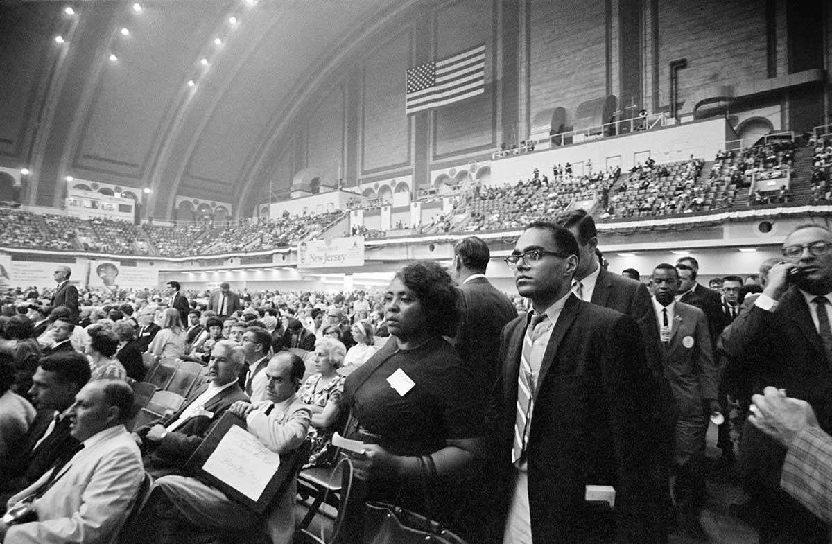Fannie Lou Hamer, Bob Moses, and Aaron Henry walk into the Convention Hall at the 1964 Democratic National Convention in Atlantic City. Image Credit: George Ballis