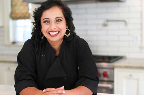 Chef Sank stands in a kitchen