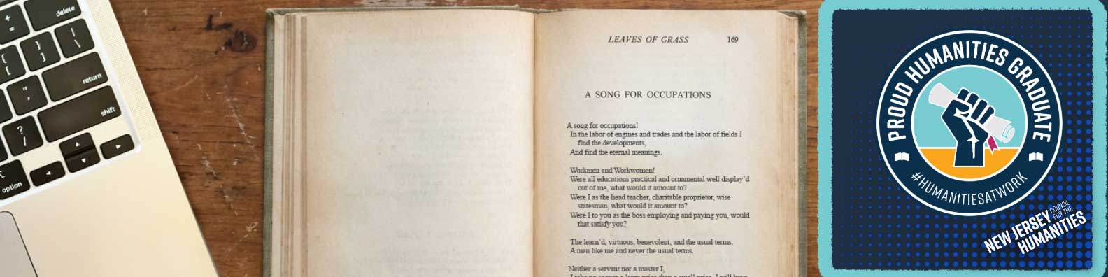 Banner image: A desktop with a partially visible laptop next to an open copy of "Leaves of Grass" and a logo overlay on the right