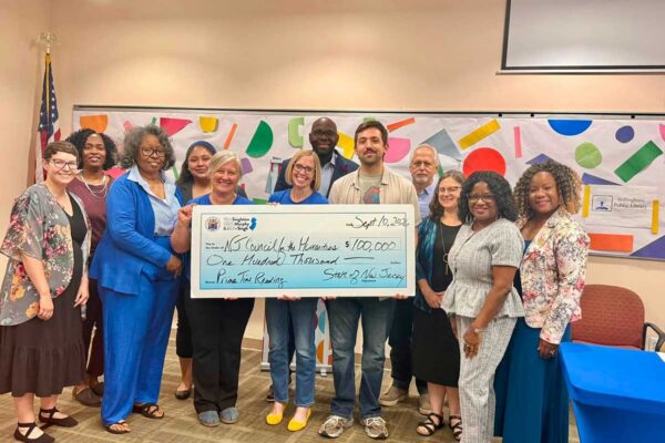 Sen. Troy Singleton presents library and council staff with a ceremonial check