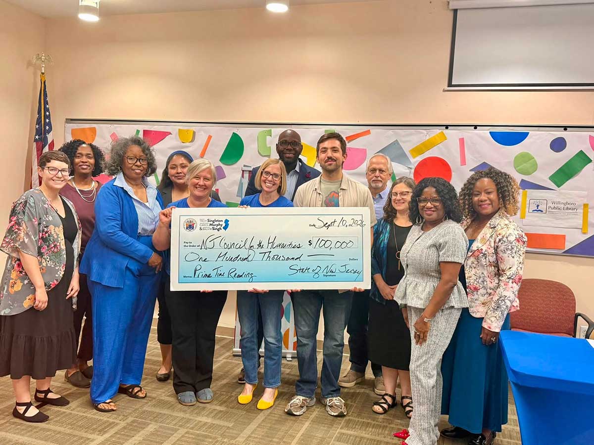 Sen. Troy Singleton presents library and council staff with a ceremonial check